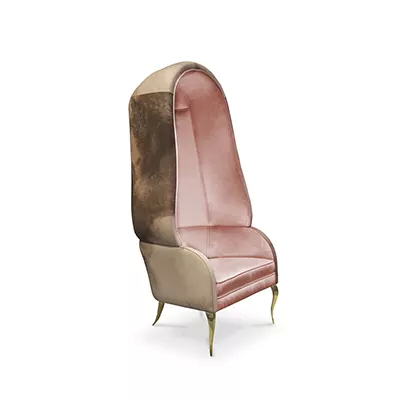 Chair with exterior trimmed in watercolor Terra leather, transitioning to a pale pink velvet interior, with curved polished brass legs.