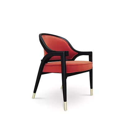 Dining chair with black wood frame, metal-tipped legs, and curved padded back and soft seat, upholstered in red.
