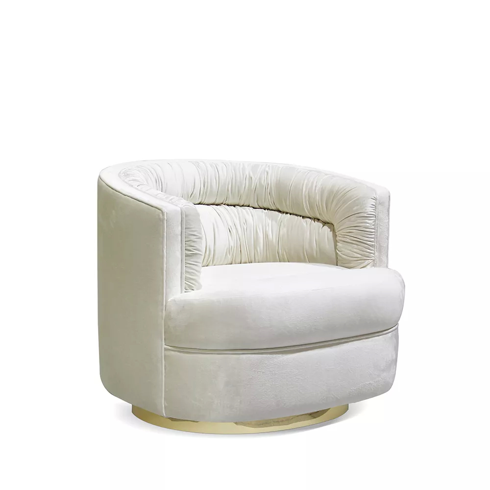 Armchair with soft creamy body and golden metallic base.